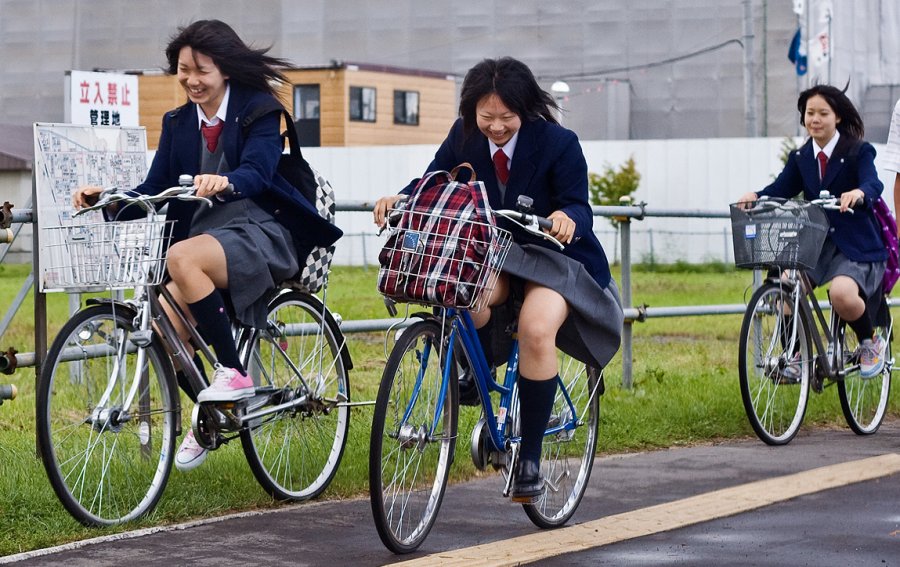 Girls taking photos on bicycles