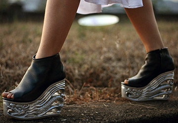 Shoes on a wooden carved wedge