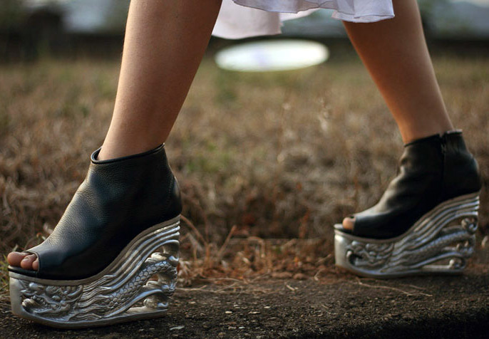 Shoes on a wooden carved wedge