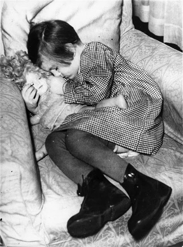 Girl sleeping with a doll - vintage photo