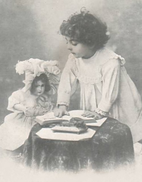 Girl playing with a doll - vintage photo