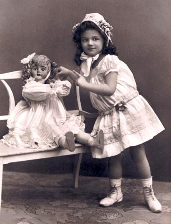 Girl playing with a doll - vintage photo