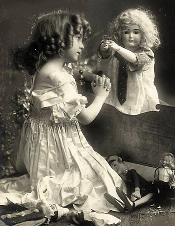 Girl playing with a doll - vintage photo