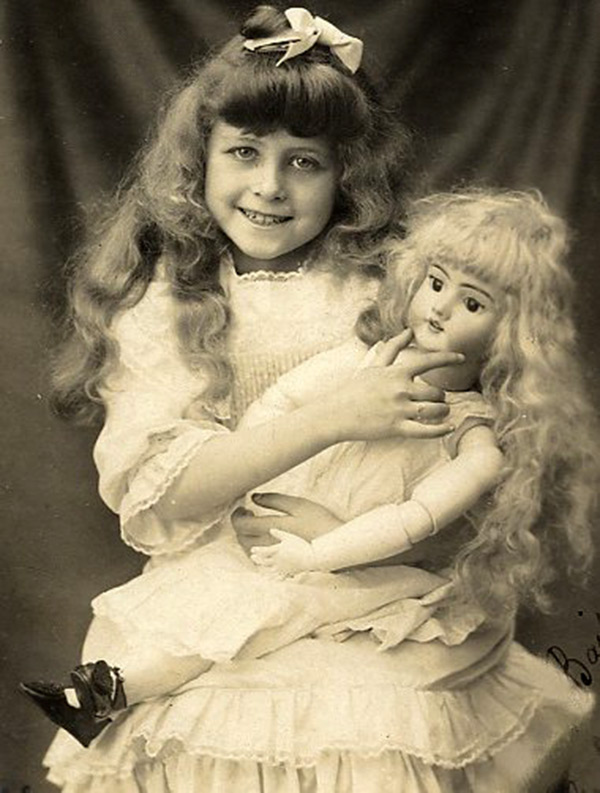 Girl playing with a doll - vintage photo