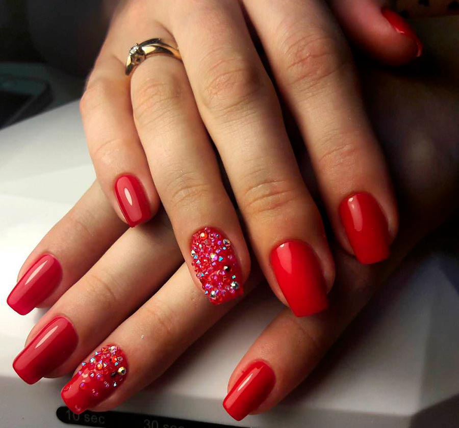 Red manicure with rhinestones